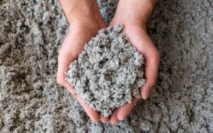 two hands holding a handful of cellulose insulation