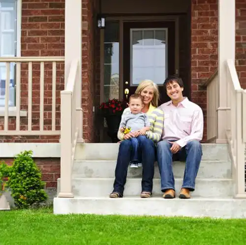 Family of three on the steps of their home -  keep pests away from your home with Springer Professional Home Services in IA