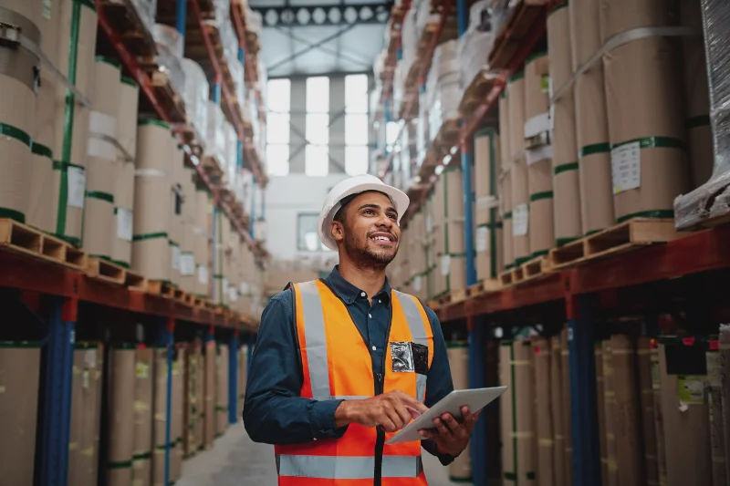 A warehouse worker smiling while working in Des Moines Iowa